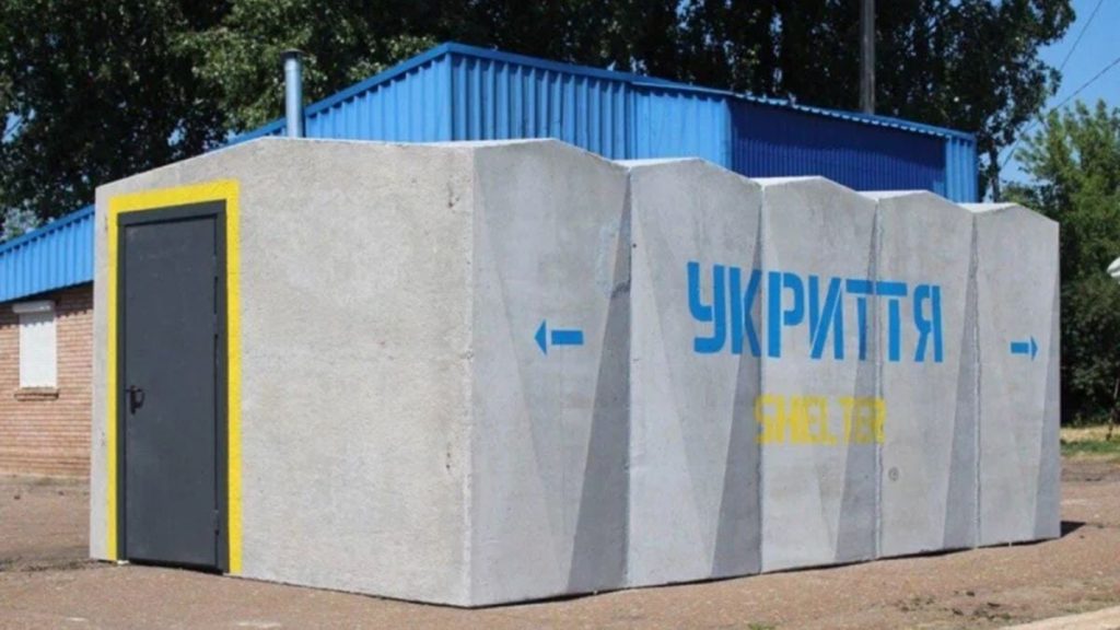 символічне фото: складений модуль укриття, аварійна ковдра і шолом на нейтральному тлі