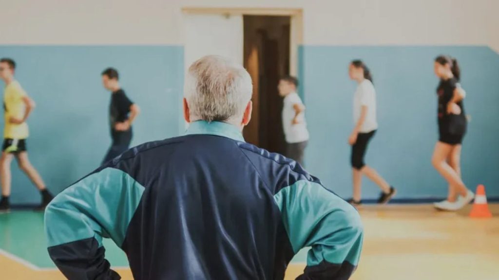 Символічна сцена: шкільна спортивна куртка і дитяче взуття на лавці біля лісової стежки