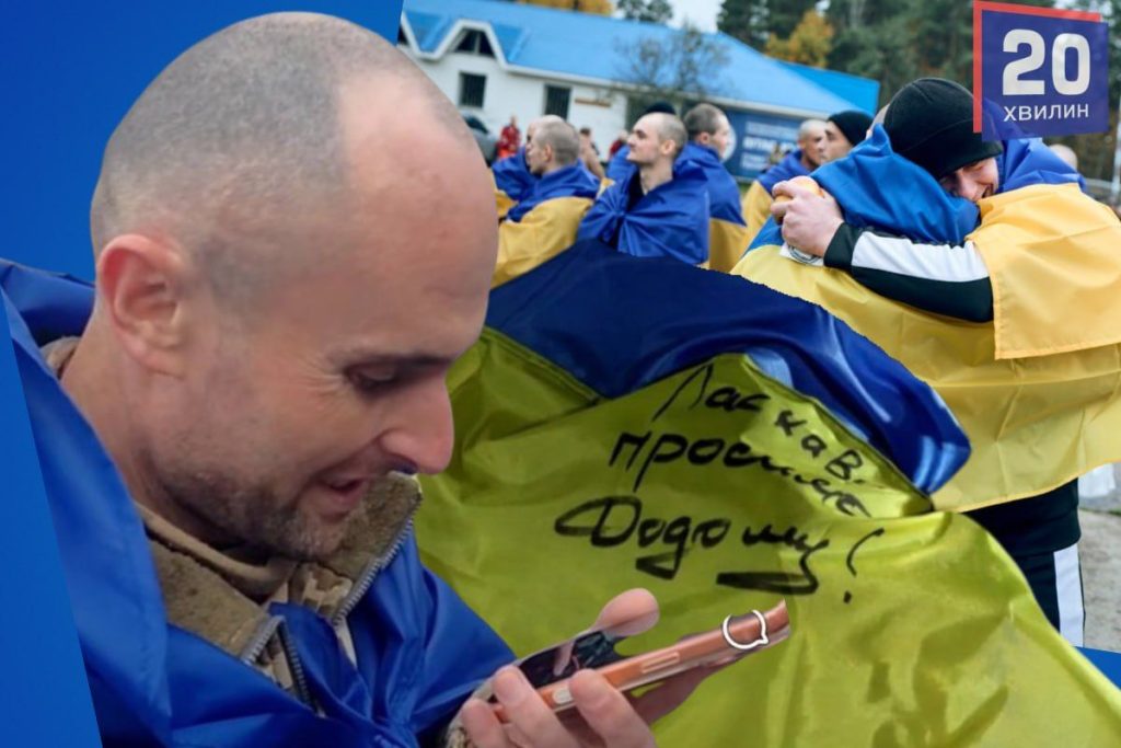 згорнутий український прапор, військові черевики і запалена свічка на деревʼяному тлі