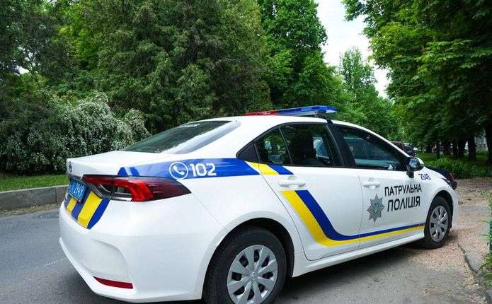 поліцейські патрульні автомобілі вночі поруч із енергетичною інфраструктурою