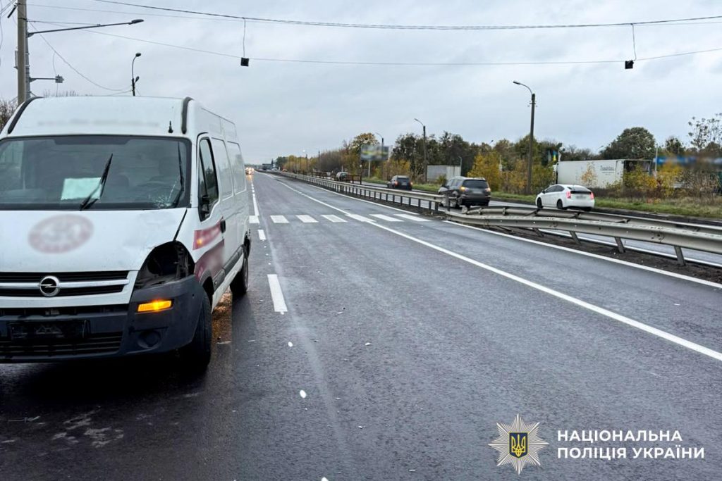 символічна сцена: шолом, світловідбивний жилет і пошкоджений знак пішохідного переходу на асфальті