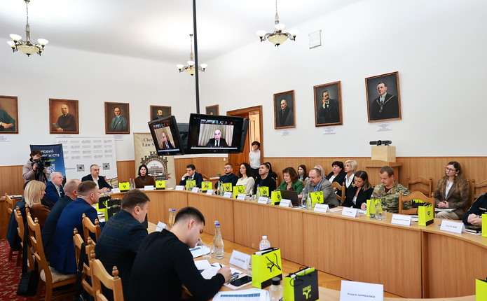 Концептуальна сцена: книги з права, ноутбук із візуалізацією нейромережі та терези правосуддя